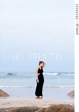 beautiful young woman standing on the sand coast beautiful young woman standing on the sand coast 29154222
