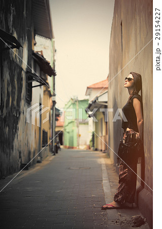 beautiful young woman standing near wall beautiful young woman standing near wall 29154227