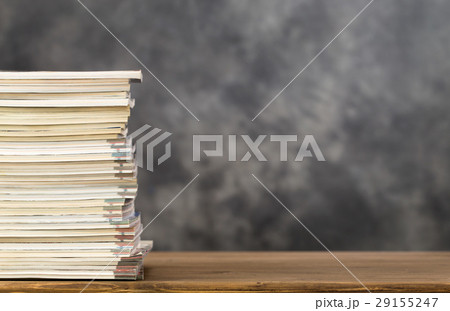 Stack of magazines on left side of table Stack of magazines on left side of table 29155247