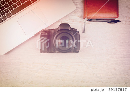 Over top photo of DSLR camera and laptop Over top photo of DSLR camera and laptop 29157617