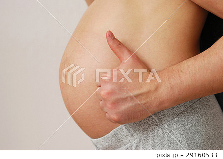 Happy husband showing OK sign on pregnant wife belly Happy husband showing OK sign on pregnant wife belly 29160533