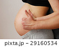 Happy young parents showing OK sign on pregnant wife belly 29160534