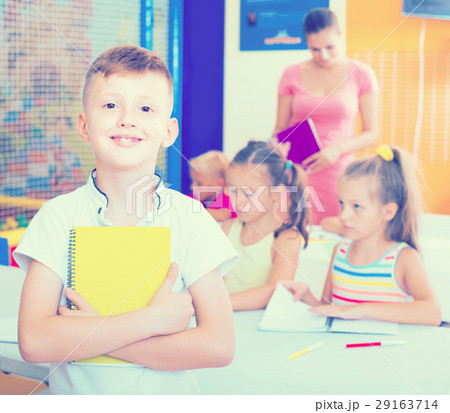 Glad boy pupil standing in elementary school class Glad boy pupil standing in elementary school class 29163714