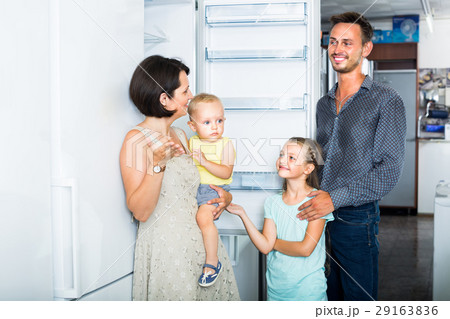 family choosing new freezer in store . family choosing new freezer in store . 29163836