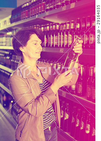 woman selecting beer at the store. woman selecting beer at the store. 29164035