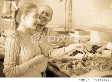 Smile man and girl choosing fish Smile man and girl choosing fish 29164451
