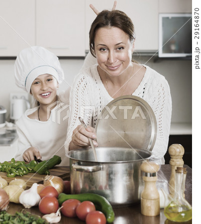 Mother and daughter cooking together 29164870