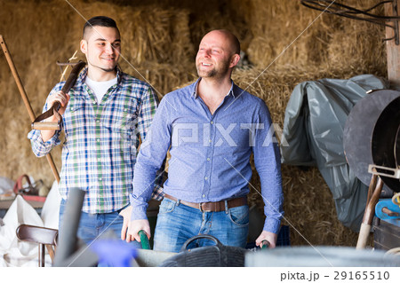 Ranchers working in a granary 29165510