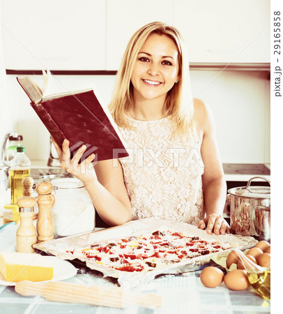 Woman making homemade pizza. Woman making homemade pizza. 29165858