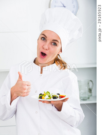 girl in chef's hat and white coat showing salad girl in chef's hat and white coat showing salad 29165923