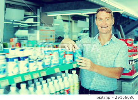 Positive man customer picking paint tin 29166036