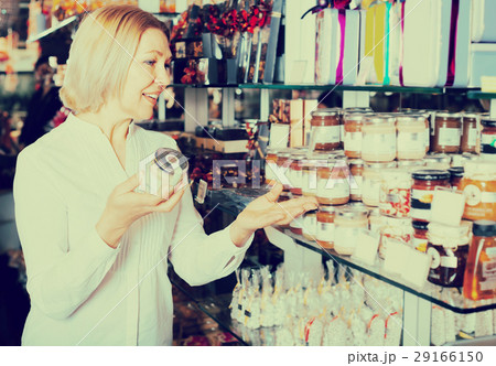 Consumer buying jar with honey. 29166150