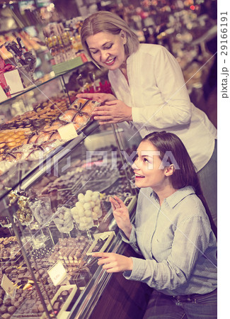 women buying dark and white chocolate filled candies women buying dark and white chocolate filled candies 29166191