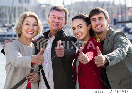 Portrait of glad young and mature couple outside 29166918