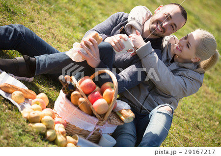Spouses lounging at picnic outdoors Spouses lounging at picnic outdoors 29167217