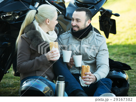 Couple posing near motor bike 29167382