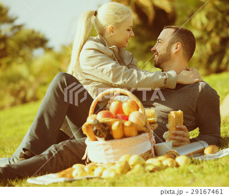 adults with apples in nature adults with apples in nature 29167461
