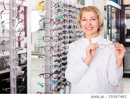 Optician standing near spectacles Optician standing near spectacles 29167462