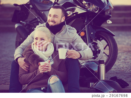 Couple posing near motor bike 29167698