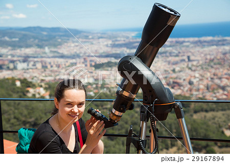 woman looking in telescope 29167894