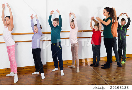 Young ballet dancers exercising in ballroom Young ballet dancers exercising in ballroom 29168188