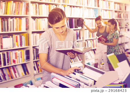 Portrait of cheerful boy looking at open book Portrait of cheerful boy looking at open book 29168423