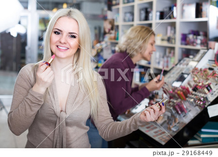 mother and daughter choosing lipstick on display and smiling mother and daughter choosing lipstick on display and smiling 29168449