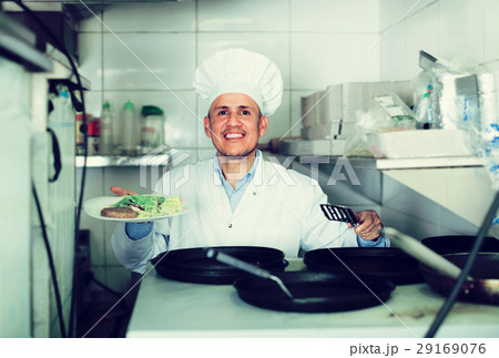 man with pans with kebab plate man with pans with kebab plate 29169076