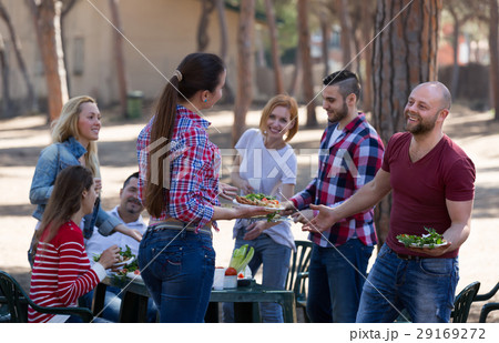 Happy friends making grill . 29169272