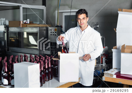 Man standing in packing section on winemaking factory 29169295