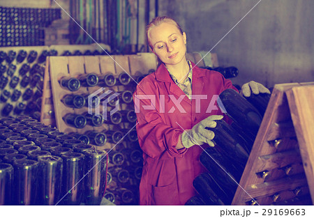 Wine maker taking care of seasoning bottles 29169663