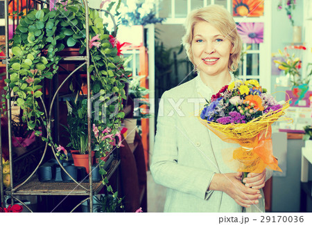 Elderly retiree female customer choosing flowers 29170036