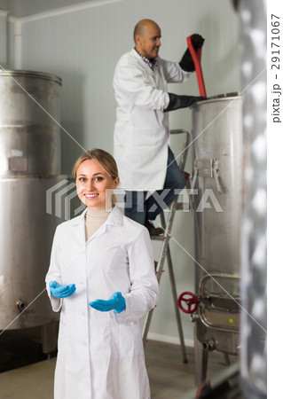 Two brewery workers on beer factory. Two brewery workers on beer factory. 29171067