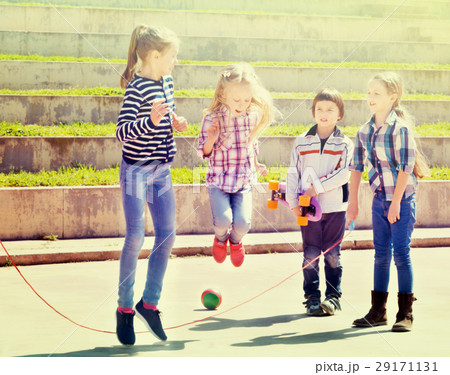 Children playing skipping rope jumping game 29171131