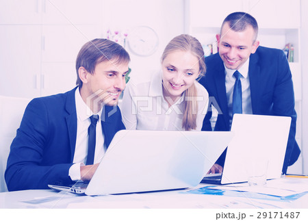 Three sociable coworkers working in company office Three sociable coworkers working in company office 29171487