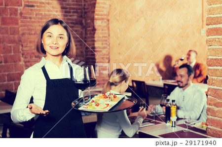 Pretty female waiter showing country restaurant Pretty female waiter showing country restaurant 29171940