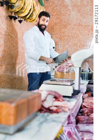 Man seller preparing meat to sell in butcher’s shop 29172113