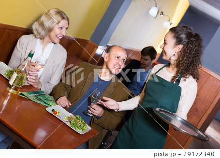 Waitress serving senior customers . Waitress serving senior customers . 29172340