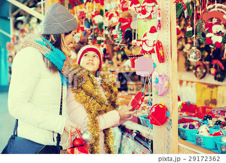 Glad woman with small daughter in market 29172362