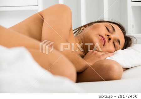 Woman sleeping in bed 29172450
