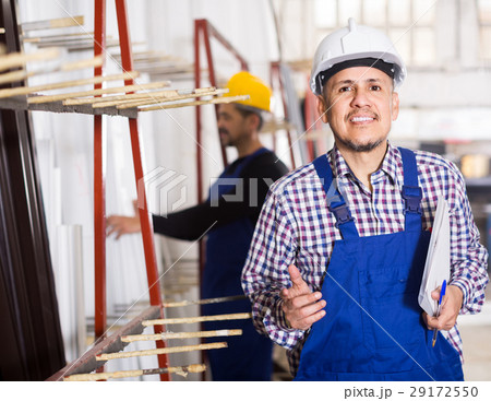 Mechanical engineer inspecting the work of labour at factory 29172550