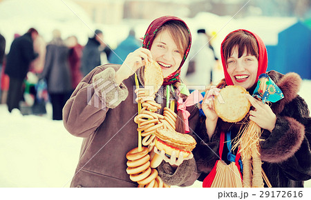 Women tasting pancake during Shrovetide 29172616