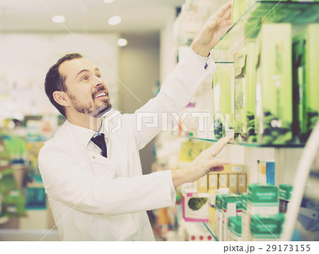 Young man pharmacist offering right drug 29173155