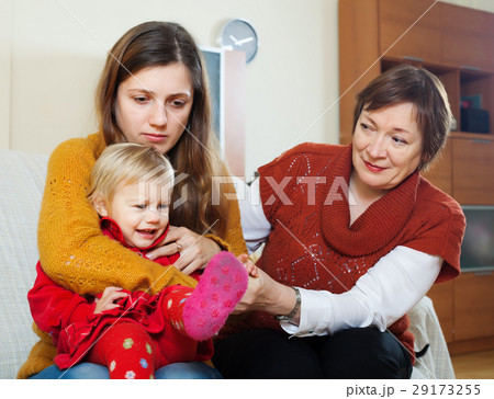 Young mother with crying baby and grandmother after quarrel 29173255