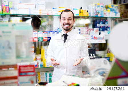 Man offer showing right drug in drugstore Man offer showing right drug in drugstore 29173261