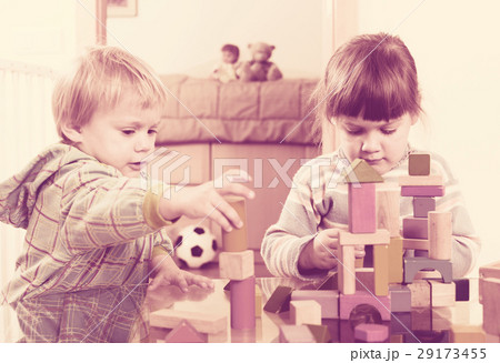 Two tranquil children playing with wooden blocks 29173455