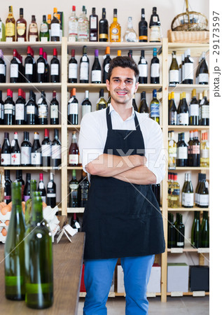seller standing in alcohol section 29173597