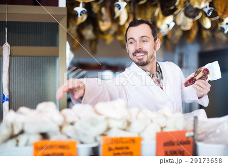 Seller offering displayed sorts of meat 29173658