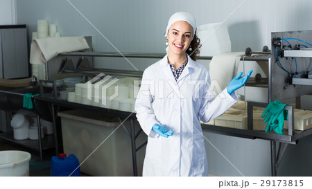 Girl in lab coat at dairy production process. Girl in lab coat at dairy production process. 29173815
