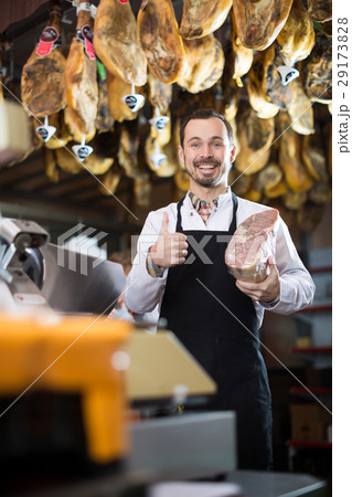 Seller offering piece of meat Seller offering piece of meat 29173828